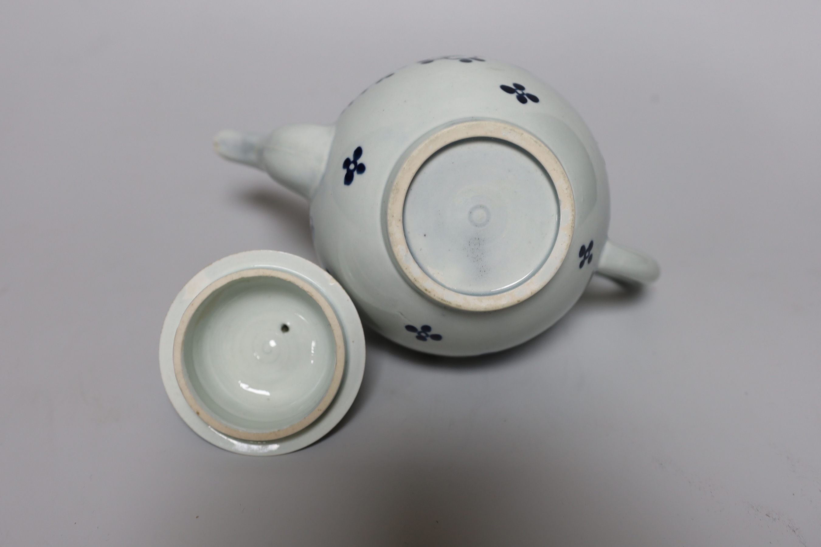 A Liverpool teapot and cover painted with flowers in underglaze blue, c.1775, 15cm tall
